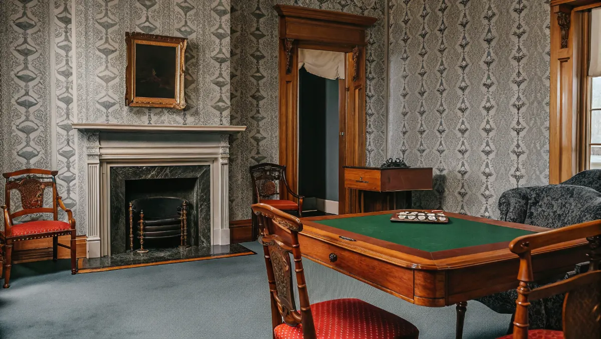 Historic Tennessee social club interior with card tables and period furniture