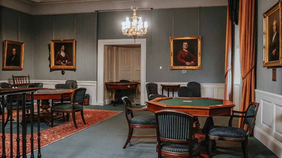 Period interior of Tennessee social club showing card tables, seating areas, and member portraits